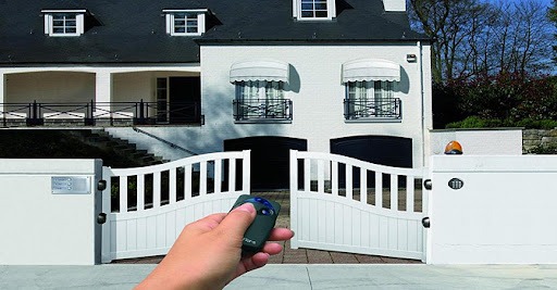 Ferforje çerçeveli ahşap çift kanatlı otomatik kapı – bahçe veya villa girişine uygun kollu motor sistemli kapı modeli